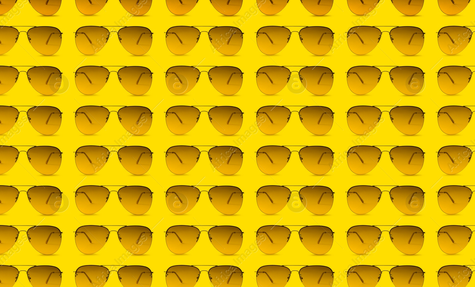 Image of Many stylish sunglasses on yellow background. Seamless pattern design