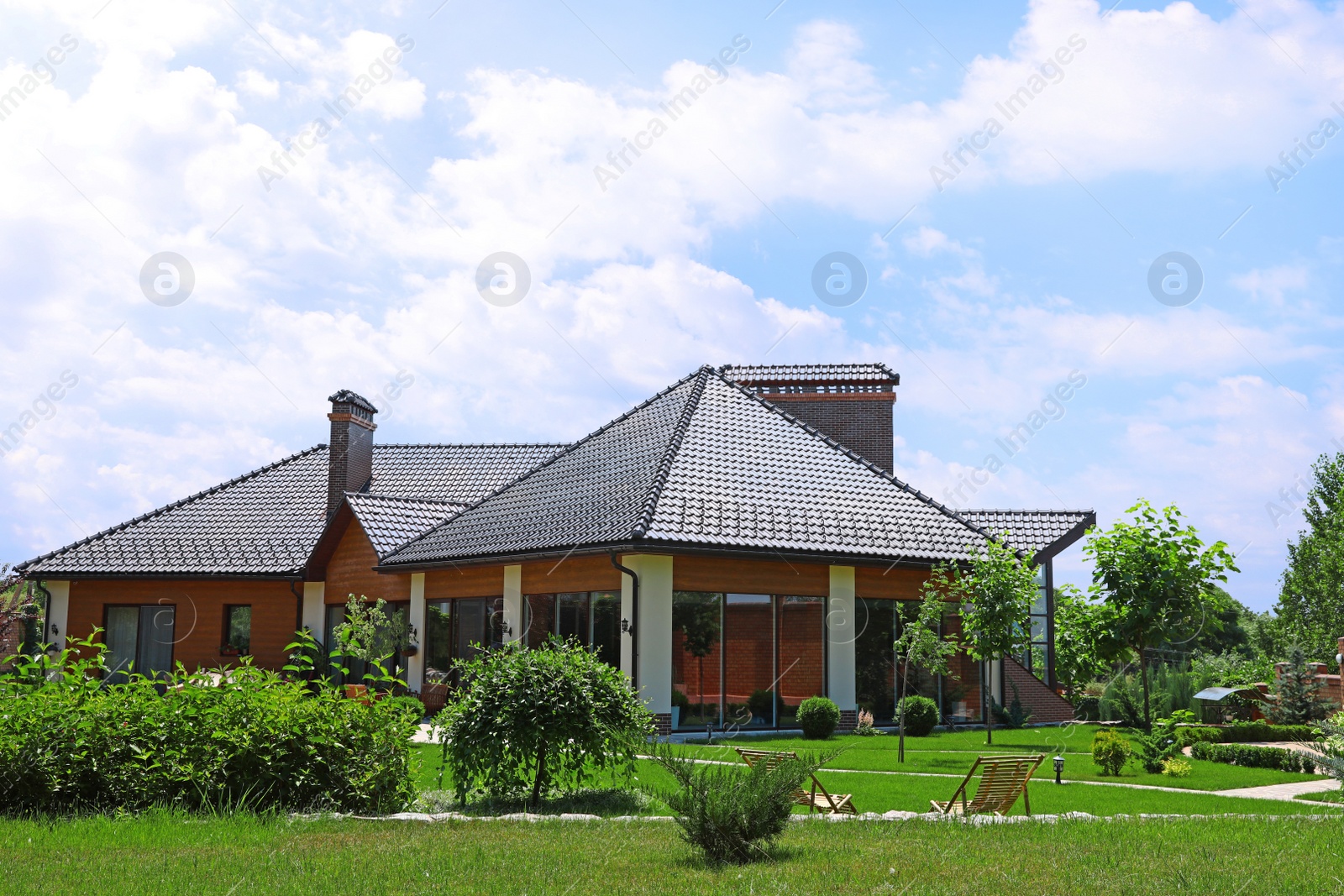 Photo of Modern house and beautiful garden on sunny day