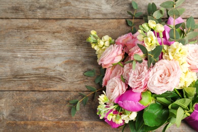 Photo of Bouquet of beautiful fragrant flowers on wooden background