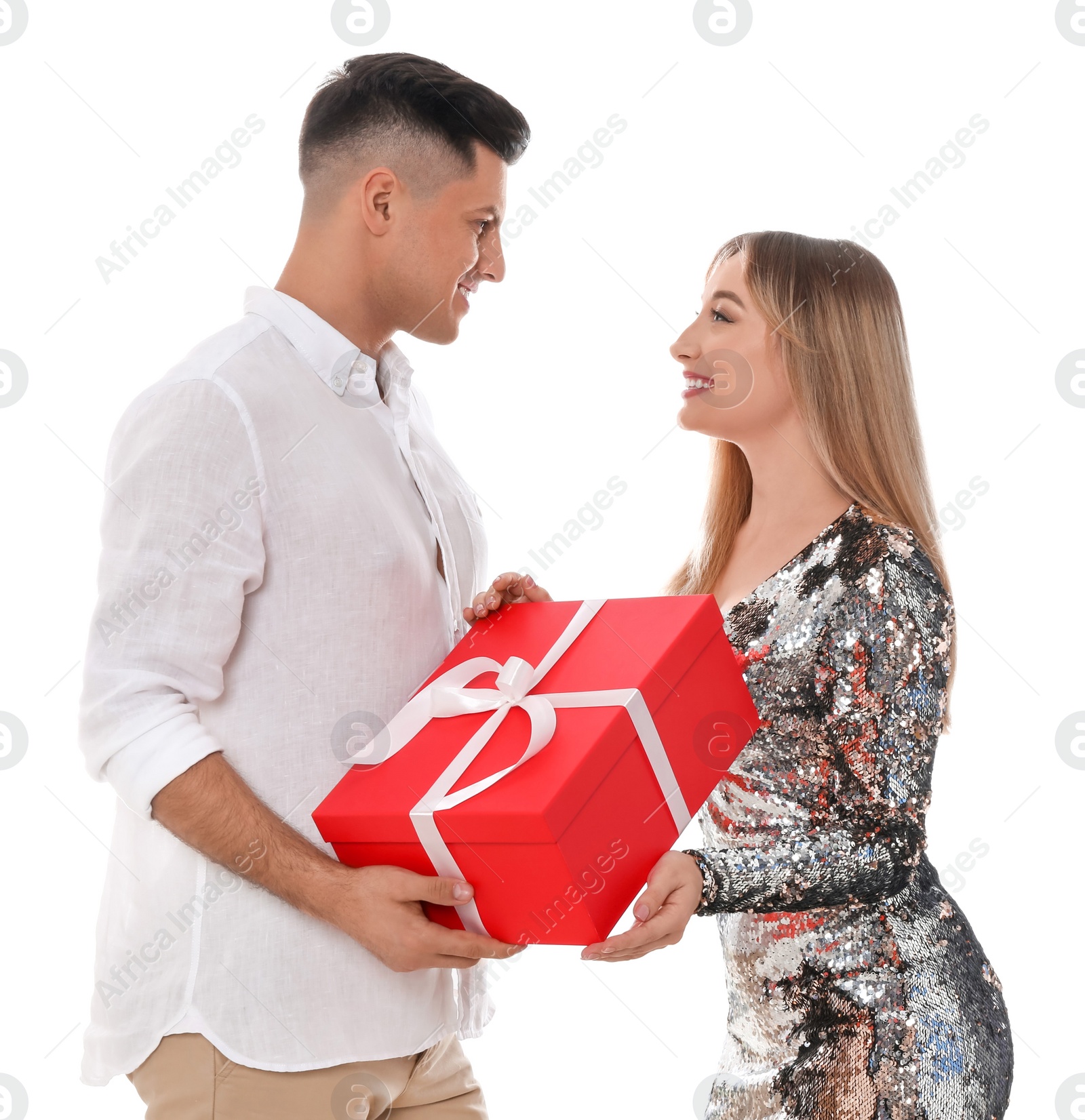 Photo of Lovely couple with gift box on white background. Valentine's day celebration