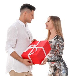 Photo of Lovely couple with gift box on white background. Valentine's day celebration