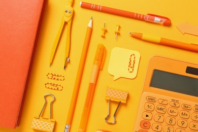 Photo of Flat lay composition with different school stationery on yellow background