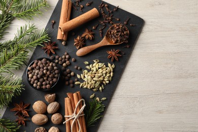Photo of Different spices on wooden table, flat lay. Space for text