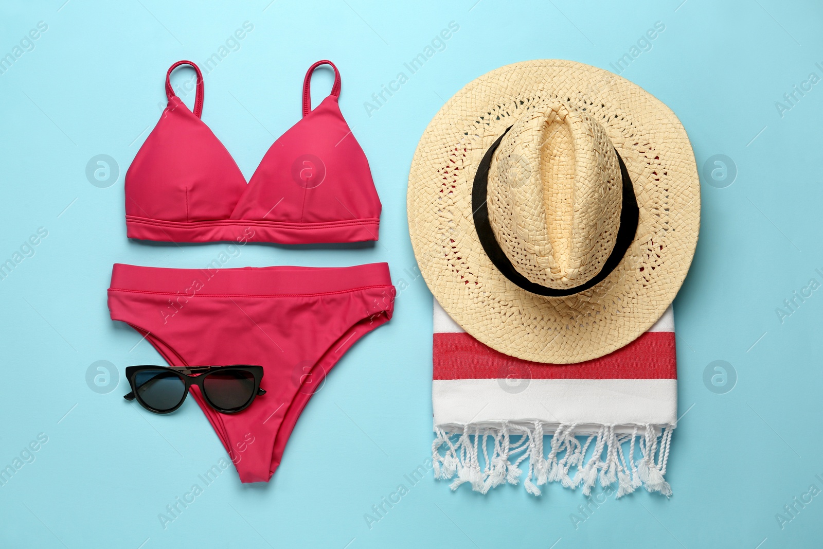 Photo of Flat lay composition with different beach objects on light blue background