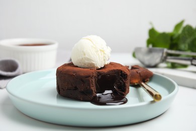 Photo of Delicious fresh fondant with hot chocolate and ice cream on white table