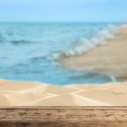 Wooden surface on sandy beach near ocean