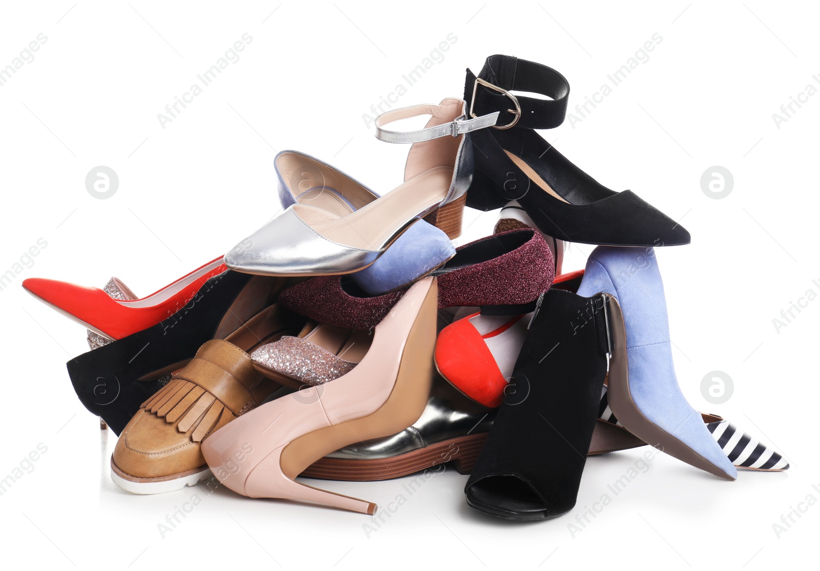 Photo of Pile of female shoes on white background