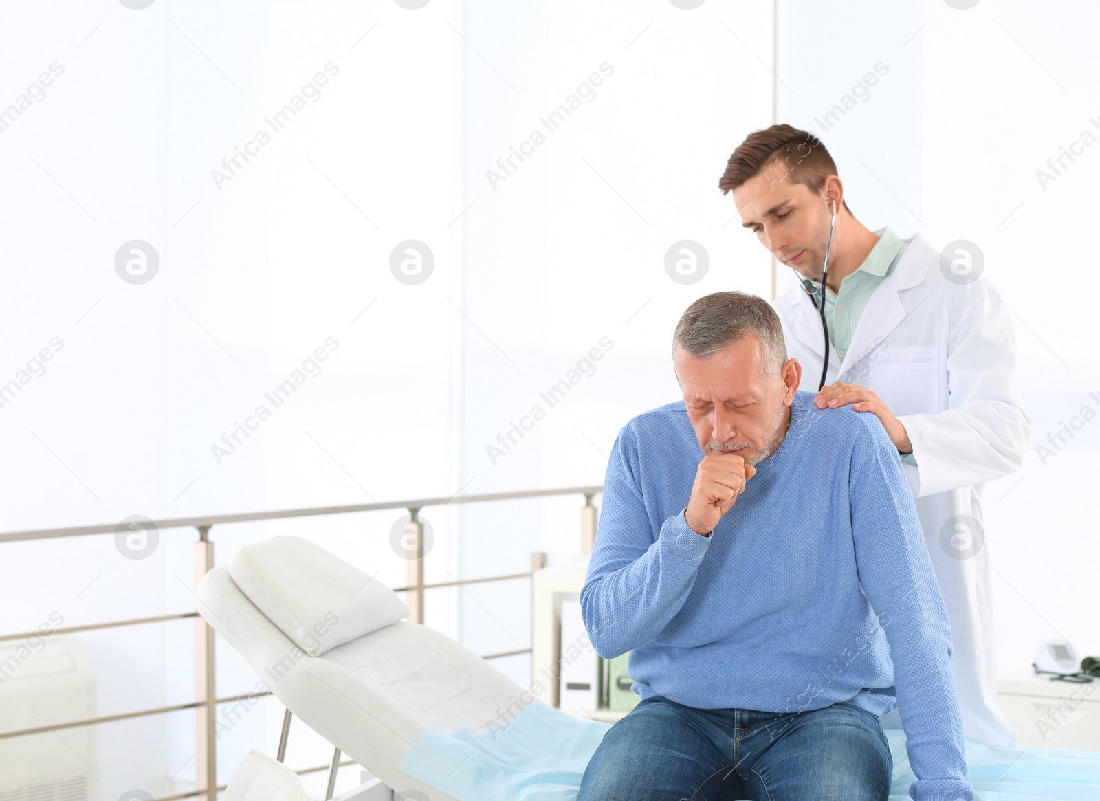 Photo of Doctor examining mature patient with stethoscope in hospital. Space for text