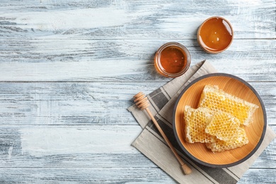 Photo of Flat lay composition with fresh honey on wooden background