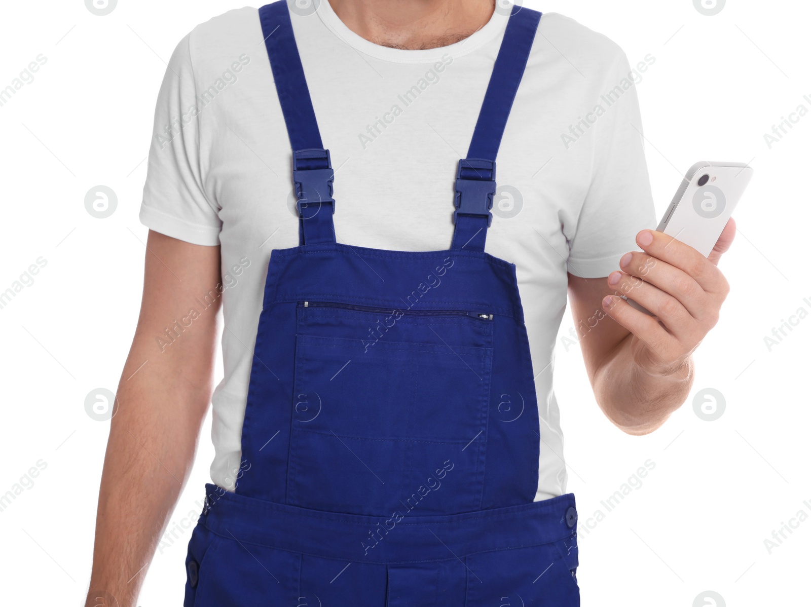 Photo of Professional repairman in uniform with phone on white background, closeup