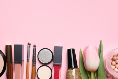 Photo of Makeup products and flower on color background, flat lay with space for text