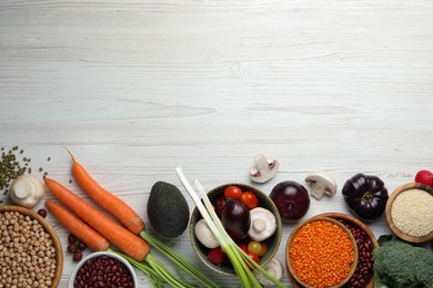 Different vegetables on white wooden table, flat lay and space for text. Vegan diet