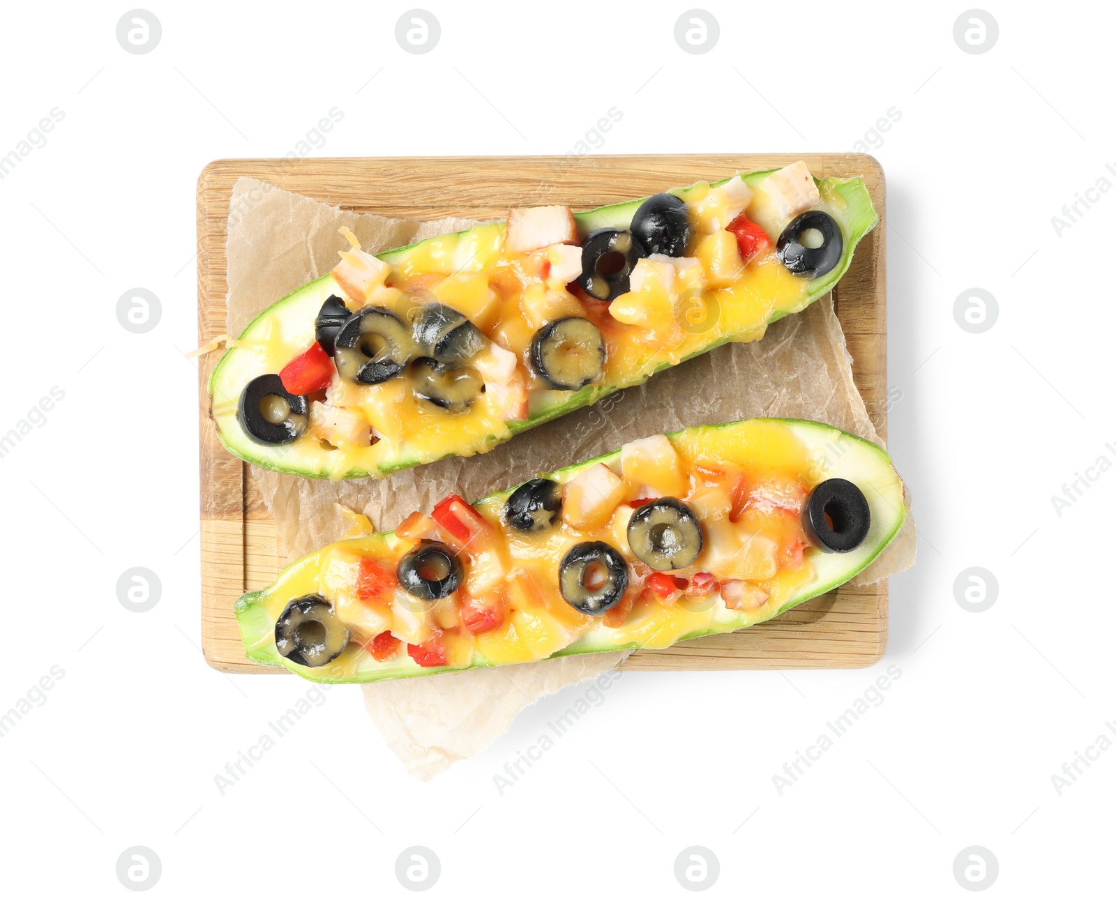 Photo of Wooden board with baked stuffed zucchinis on white background, top view