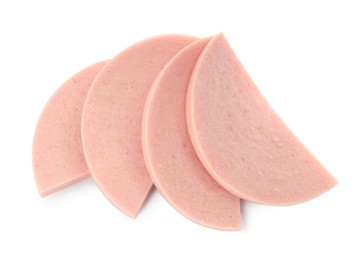 Photo of Slices of tasty boiled sausage on white background, top view