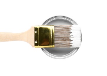Photo of Can of color paint with brush isolated on white, top view