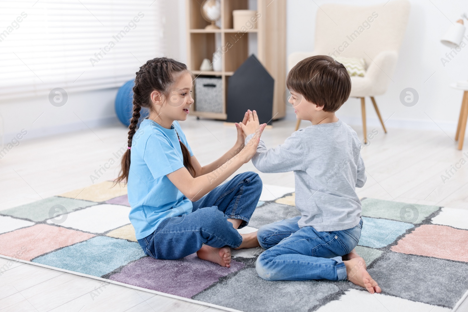 Photo of Happy brother and sister spending time together at home