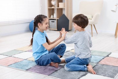 Photo of Happy brother and sister spending time together at home