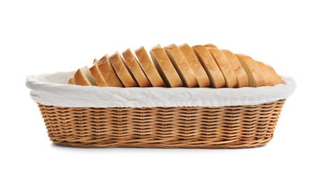 Sliced tasty fresh bread in wicker basket on white background