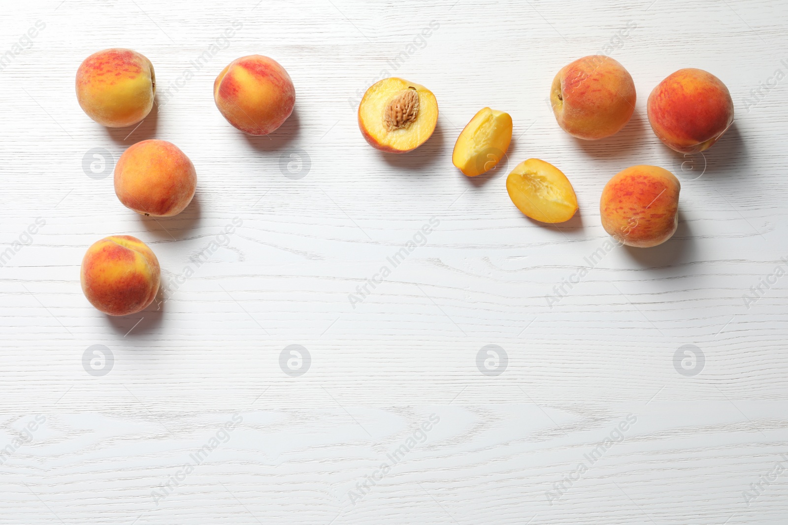 Photo of Fresh sweet peaches on wooden table, top view