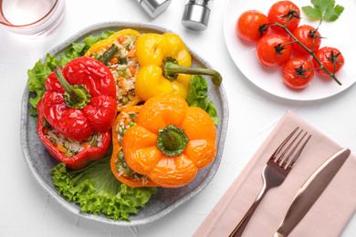 Photo of Tasty stuffed bell peppers served on white table, flat lay