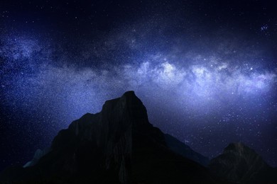 Image of Picturesque view of starry sky over mountains at night