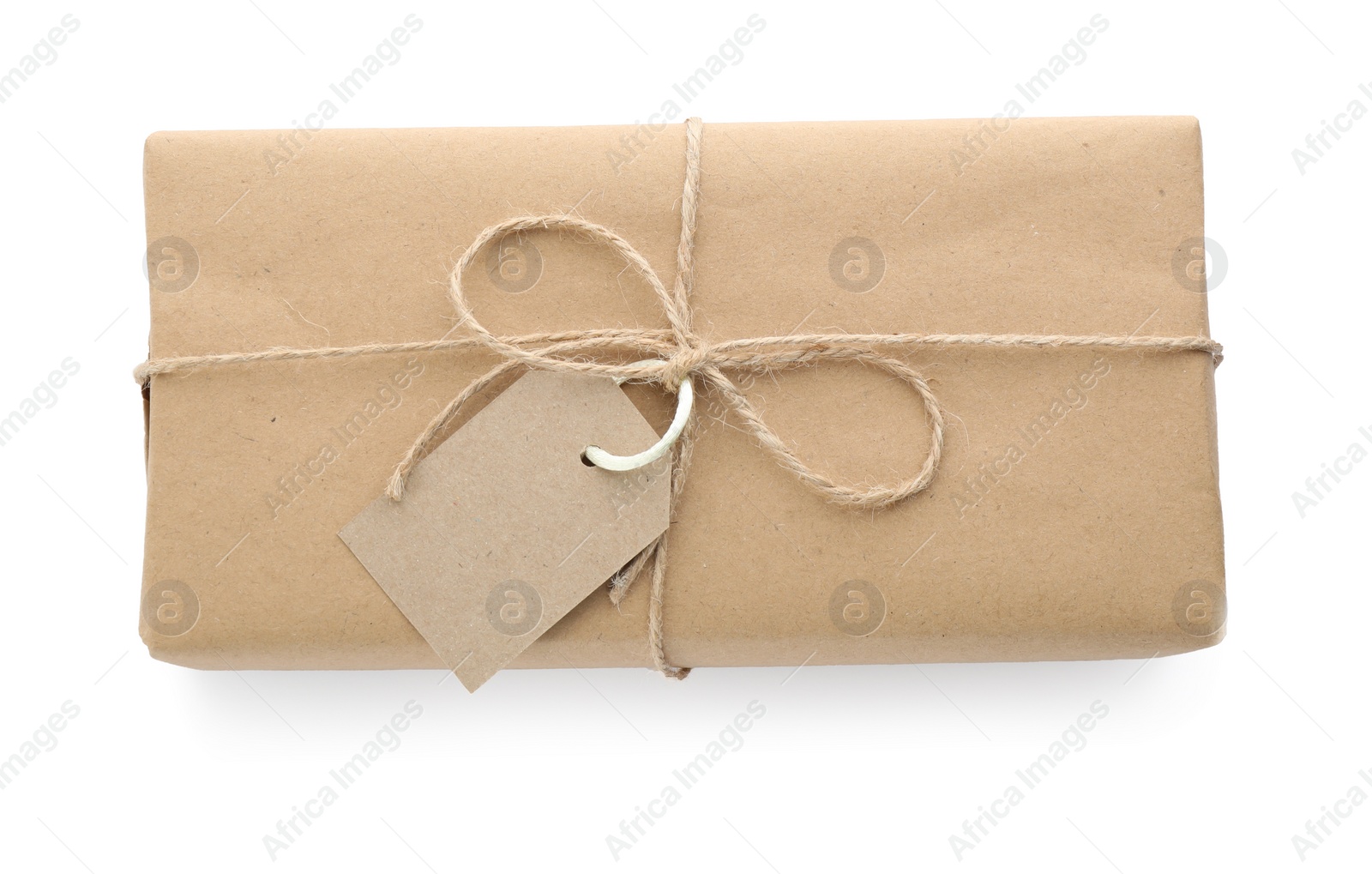 Photo of Parcel wrapped with kraft paper, twine and tag isolated on white, top view