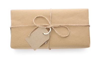 Photo of Parcel wrapped with kraft paper, twine and tag isolated on white, top view