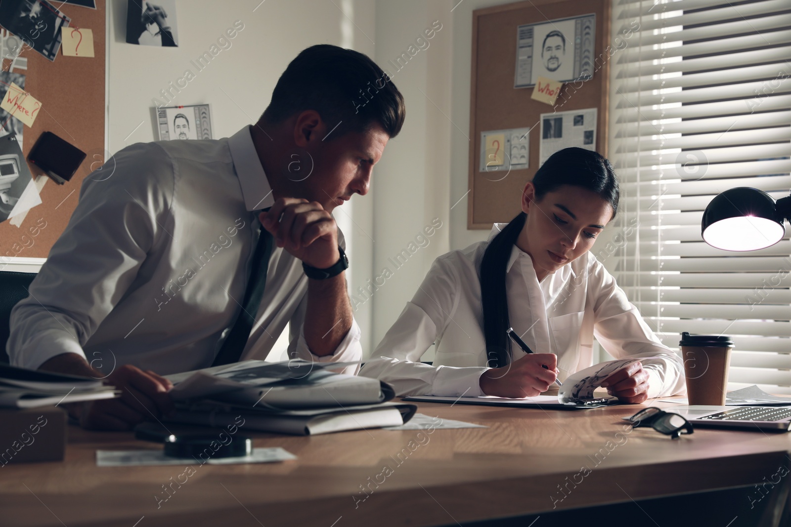 Photo of Professional detectives working at desk in office