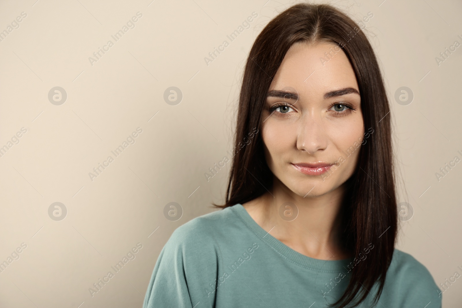 Photo of Portrait of pretty young woman with gorgeous chestnut hair on light background, space for text