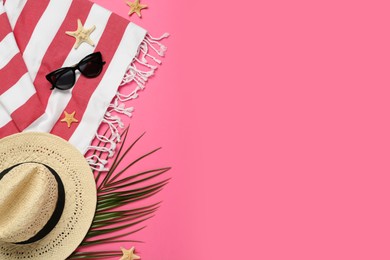 Flat lay composition with different beach objects on pink background, space for text