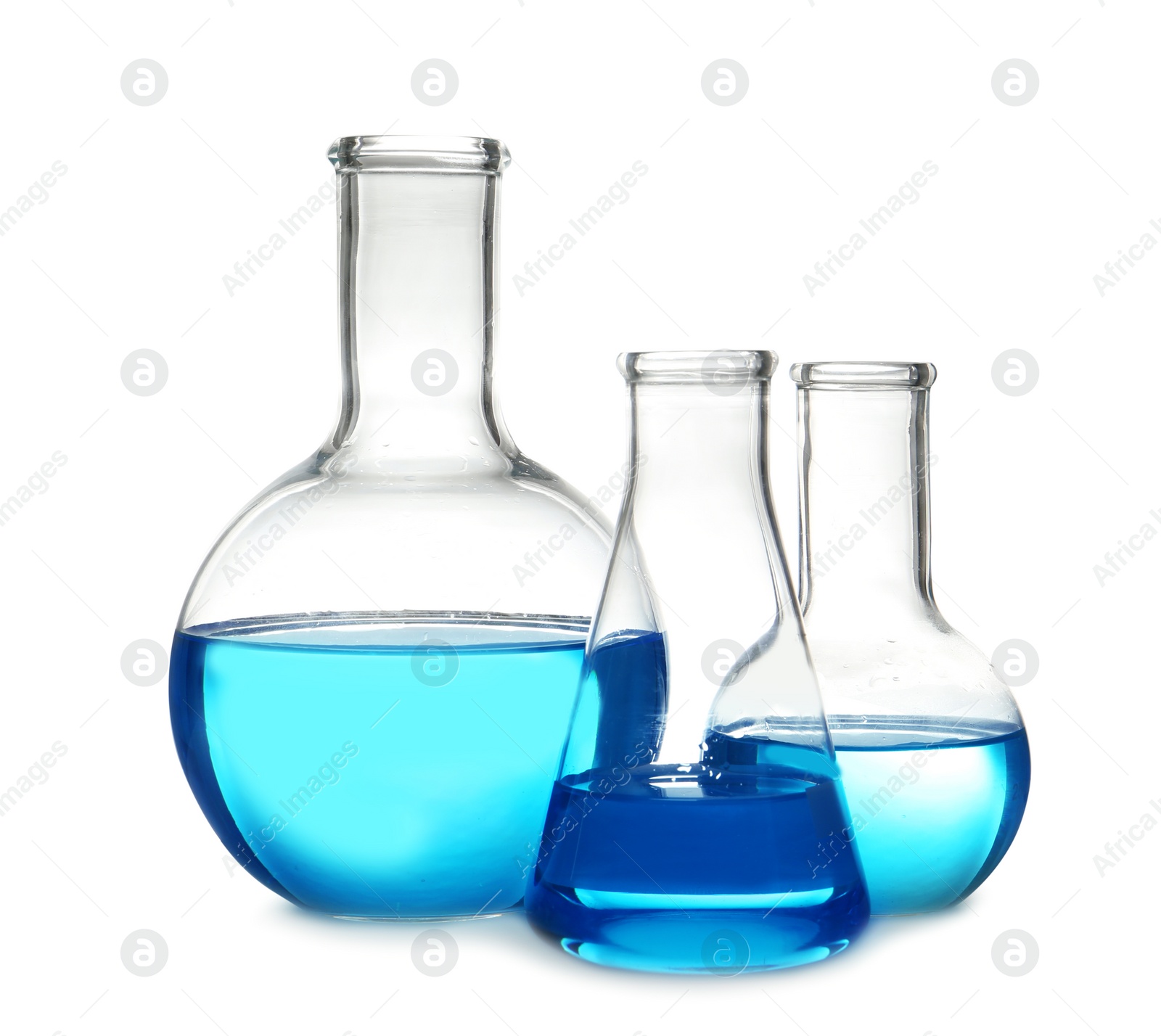 Photo of Laboratory glassware with liquid on table against white background. Chemical analysis