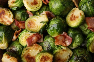 Photo of Delicious roasted Brussels sprouts and bacon as background, top view
