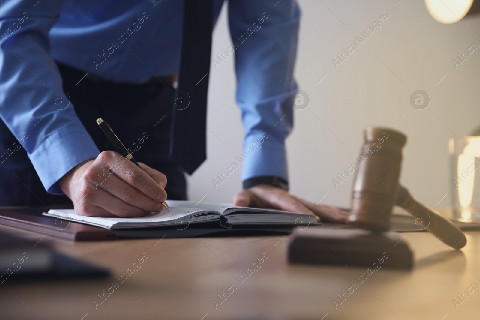 Photo of Male lawyer working at table in office, closeup