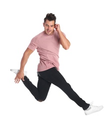 Photo of Young man in stylish jeans jumping on white background