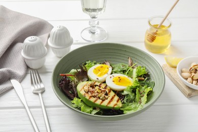 Photo of Healthy dish high in vegetable fats on white wooden table, closeup