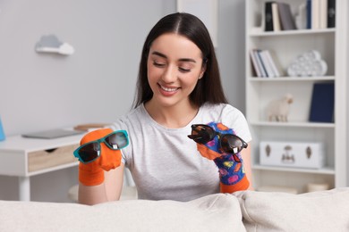 Happy woman performing puppet show at home