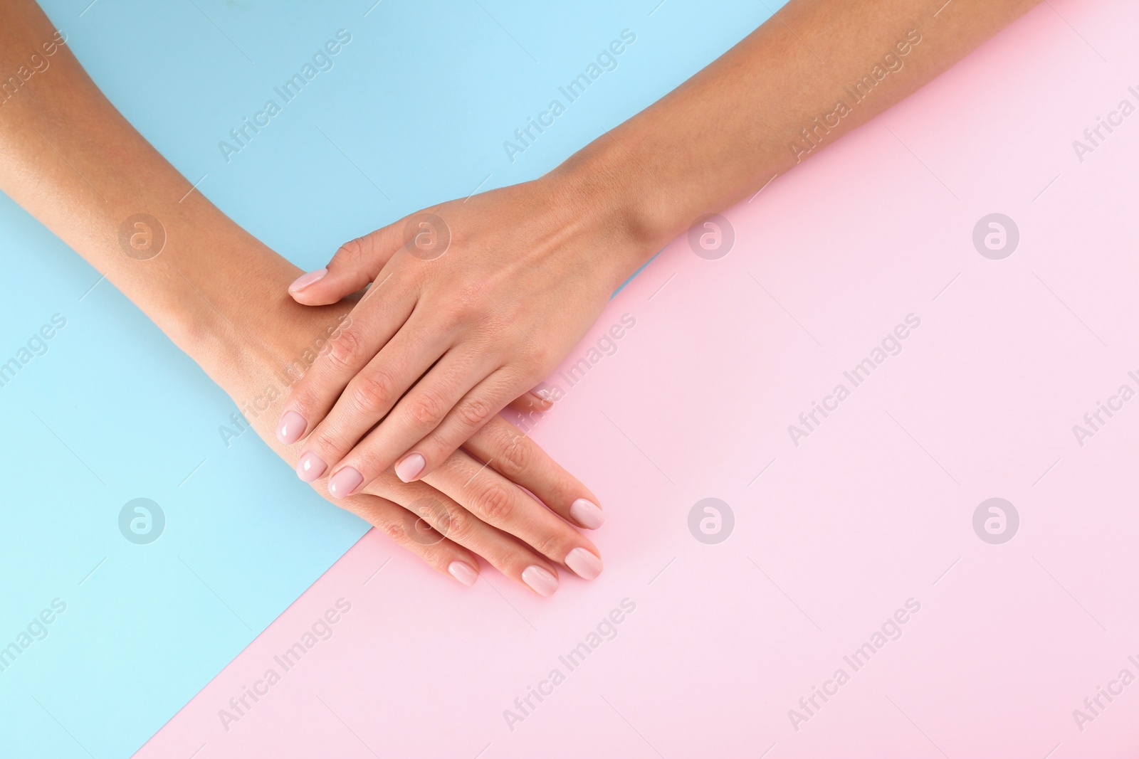 Photo of Closeup view of woman with beautiful hands on color background, space for text. Spa treatment