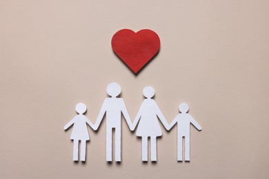 Photo of Paper family figures and red heart on beige background, flat lay. Insurance concept