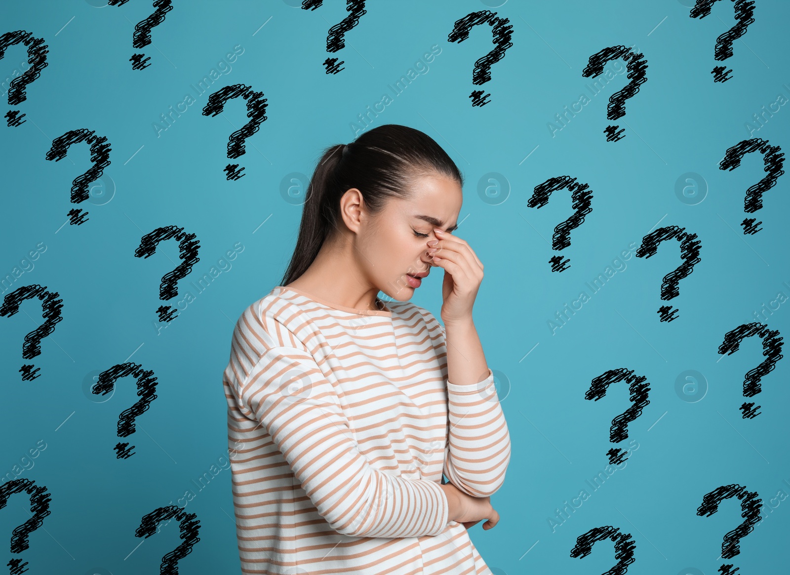 Image of Amnesia. Confused young woman and question marks on light blue background