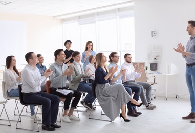 Photo of Male business trainer giving lecture in office