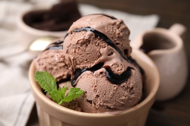 Photo of Bowl of tasty chocolate ice cream, closeup