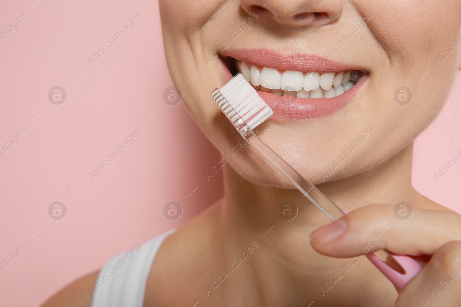 Photo of Woman with toothbrush on color background, closeup. Space for text