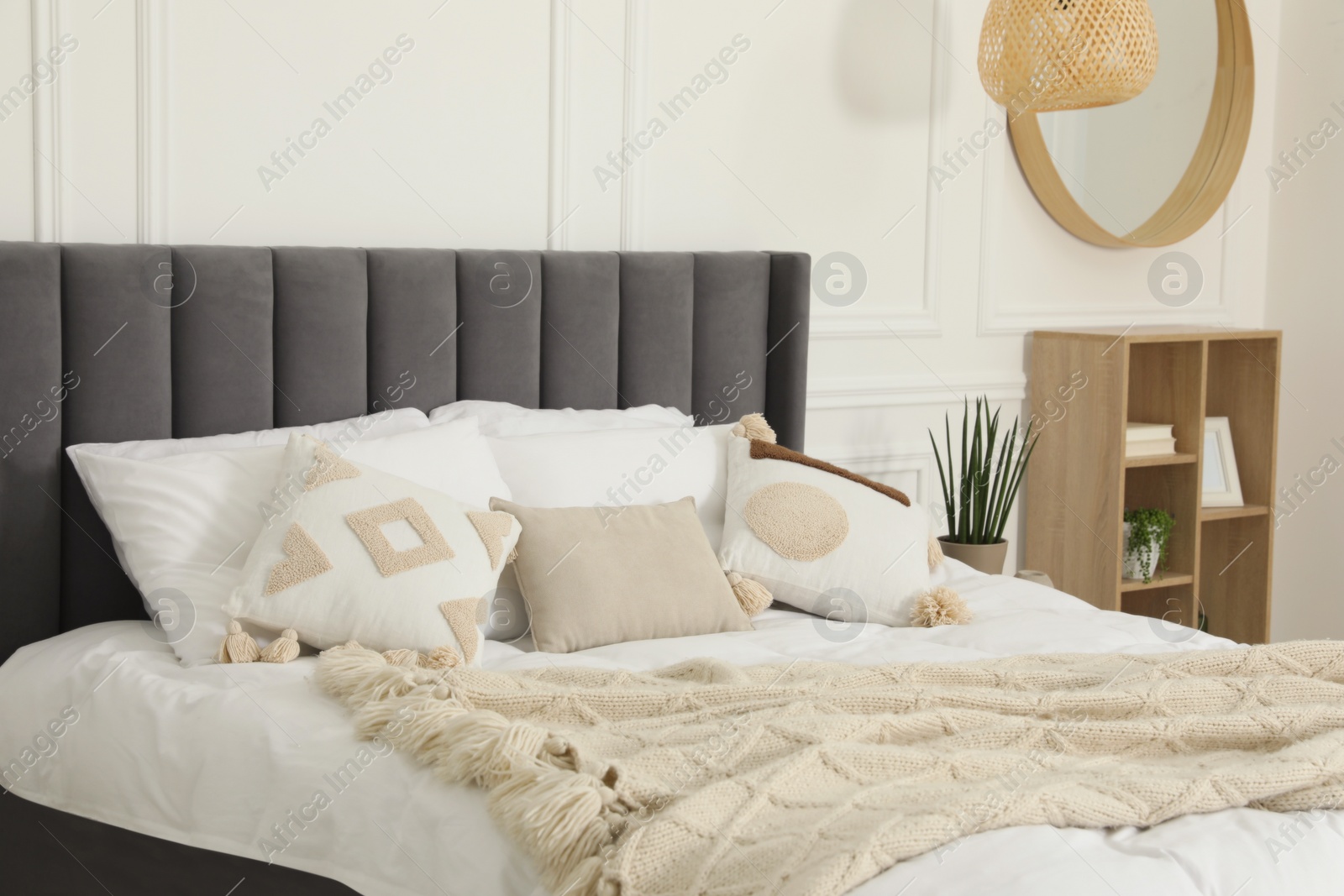 Photo of Stylish bedroom interior with large comfortable bed and pillows