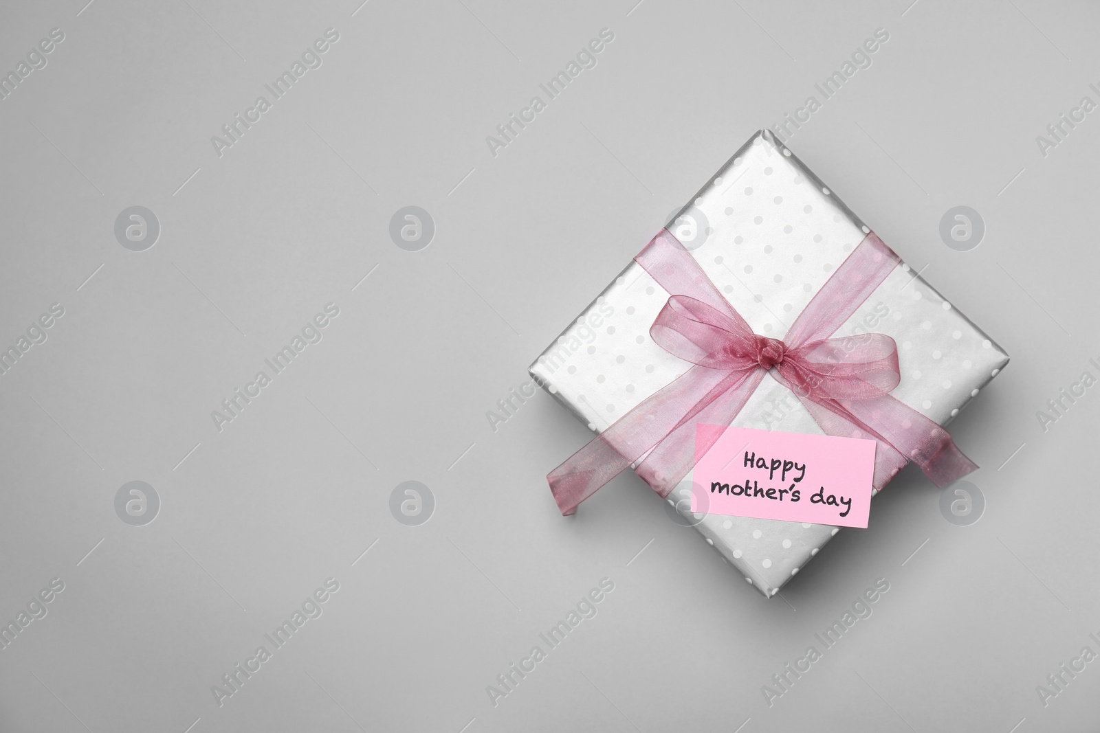 Photo of Elegant gift box for Mother's Day on light background, top view