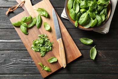 Fresh green basil on black wooden table, flat lay