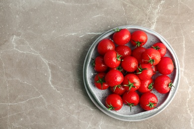 Photo of Plates with fresh ripe tomatoes on grey background, top view