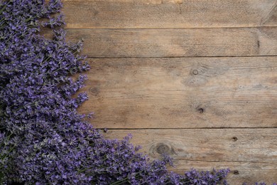 Photo of Beautiful lavender flowers on wooden background, flat lay. Space for text