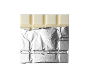 Photo of Delicious chocolate bar wrapped in foil isolated on white