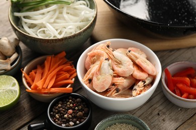 Photo of Different products for cooking wok on wooden table, closeup