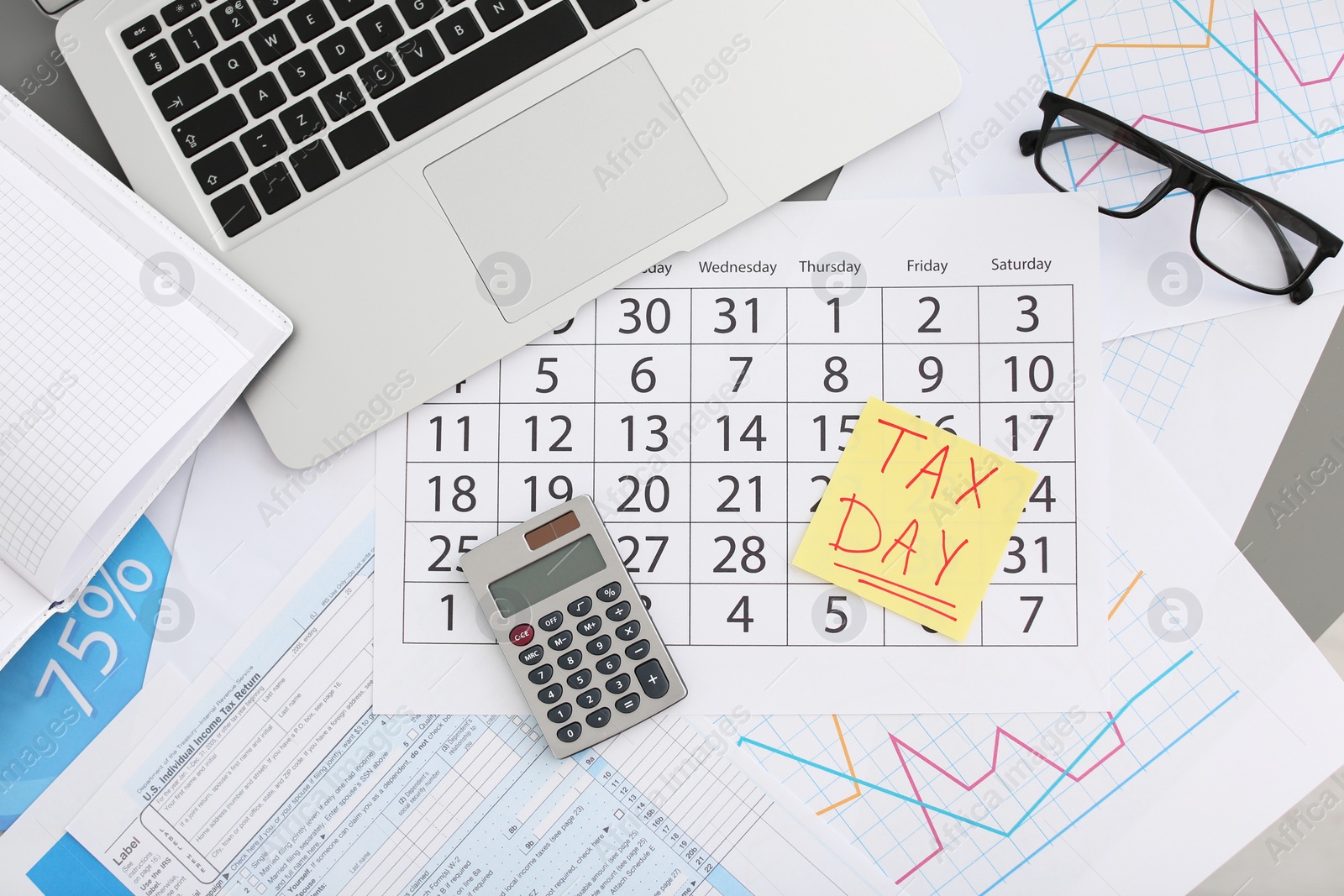 Photo of Flat lay composition with calendar, calculator and glasses on table. Tax day